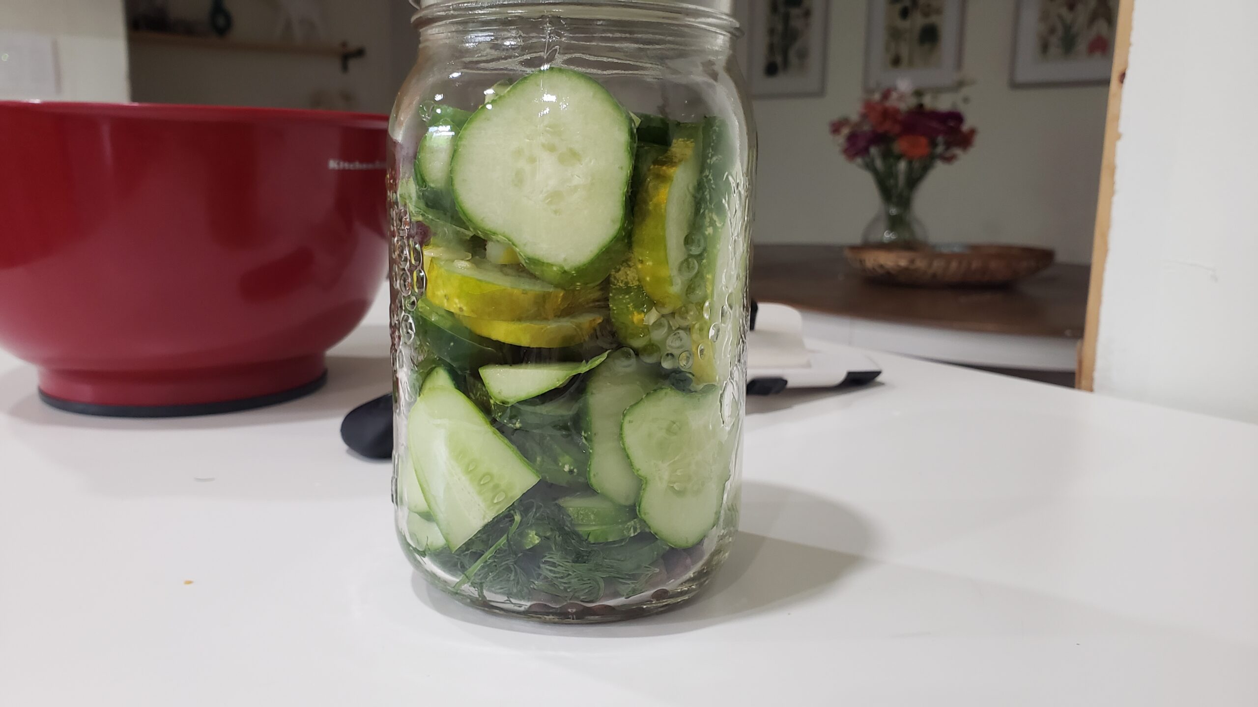 a mason jar is filled to the top with sliced cucumbers