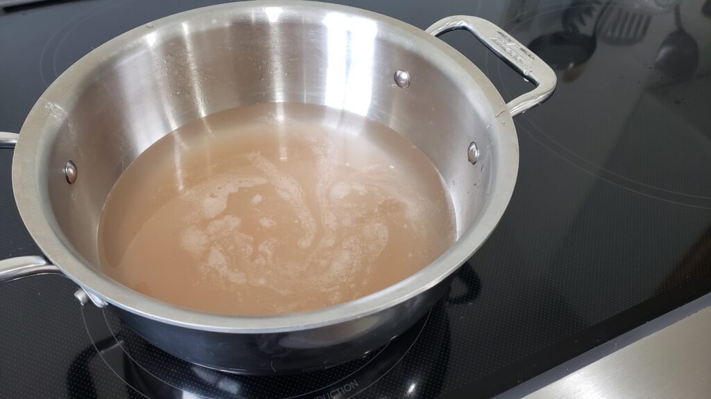 a stainless steel pot is filled with salty brine