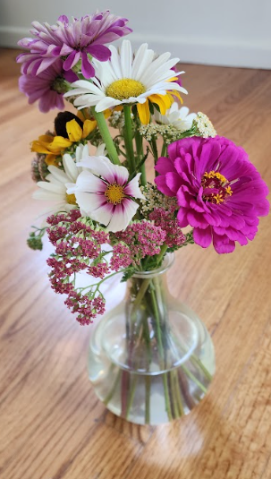 pink and white flowers are cut fresh from a garden in a vase