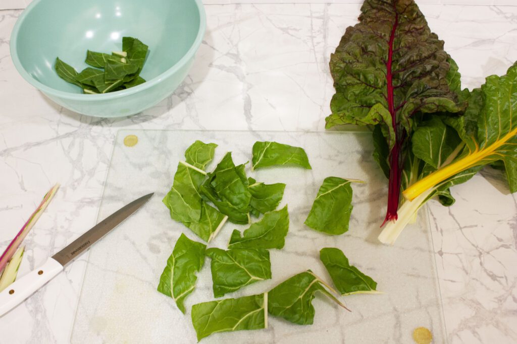a swiss chard leaf is cut into square pieces
