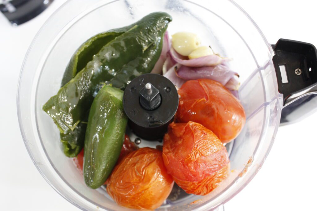 broiled vegetables sit in a food processor