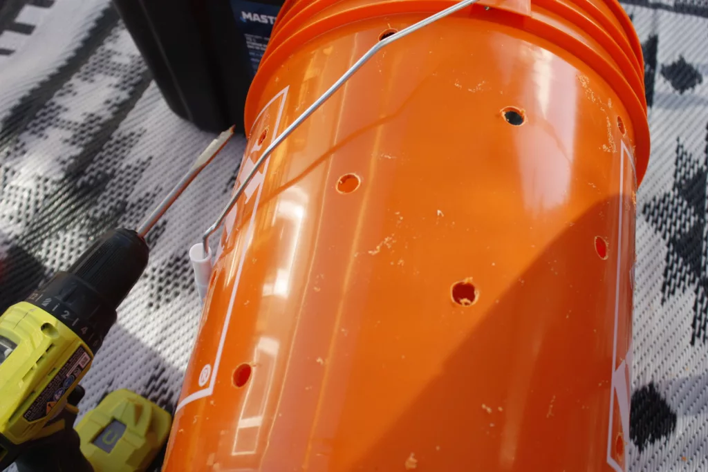 a bucket with 1/2" holes drilled into it for mushrooms
