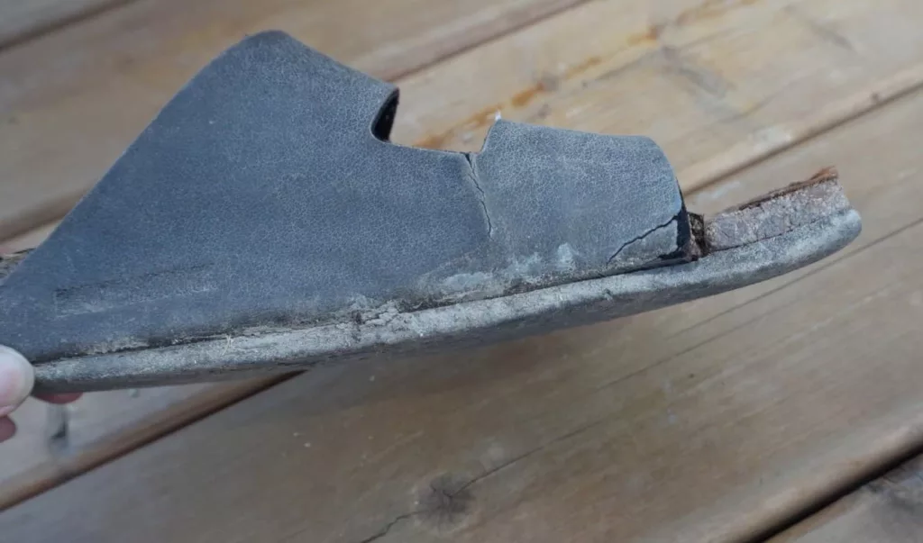 a pair of broken Birkenstock sandals ruined from gardening
