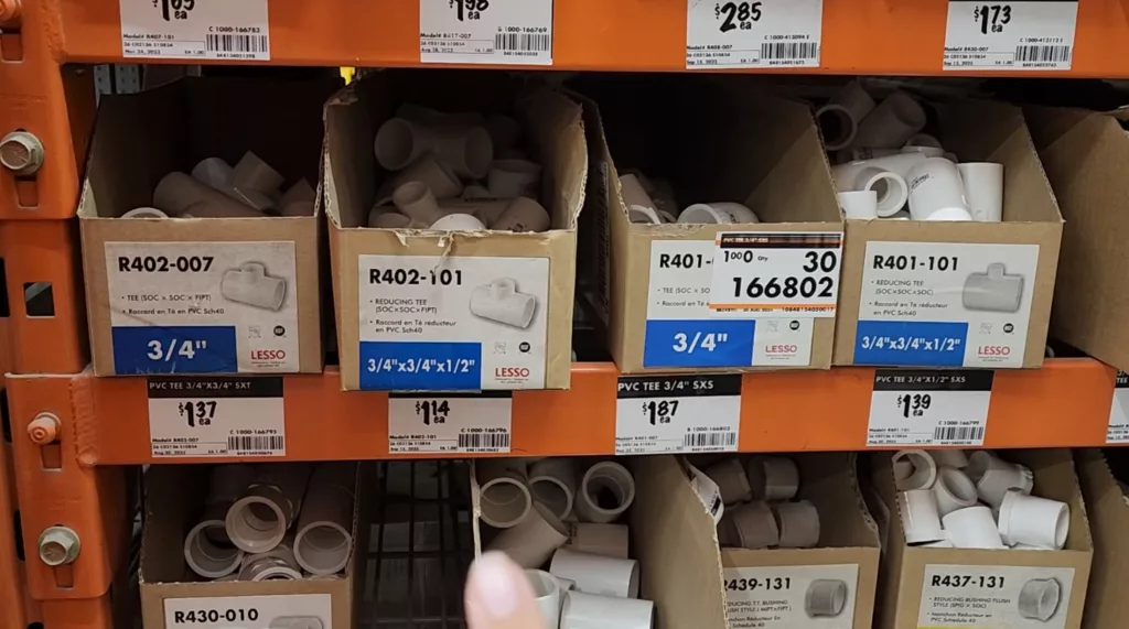 PVC connector IPEX pieces sit in boxes on a shelf in a store